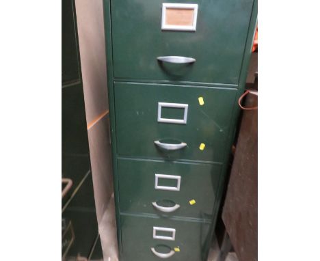 A vintage green four drawer filing cabinet