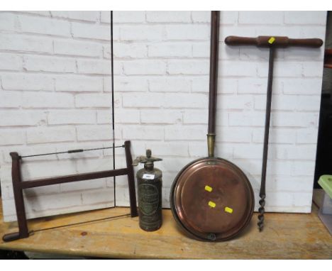 A vintage T handled wood auger, a vintage bow saw, a vintage fire extinguisher and a vintage bed warmer pan