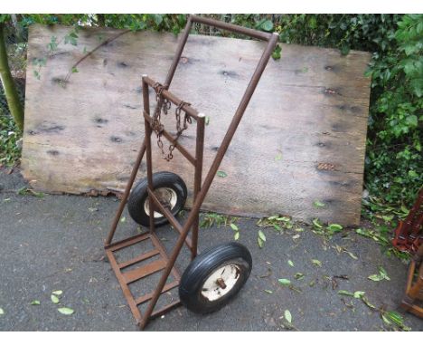 A vintage welding gas bottle trolley