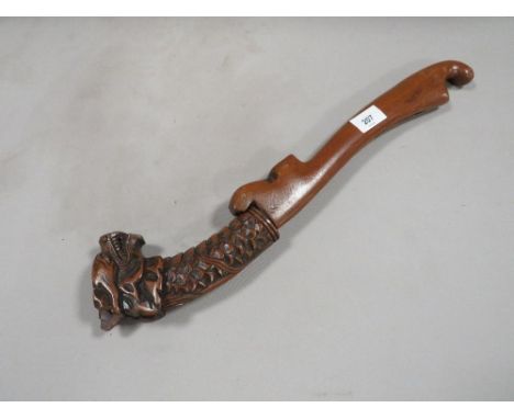 A vintage Far Eastern dagger with wooden scabbard and carved dragons head to handle
