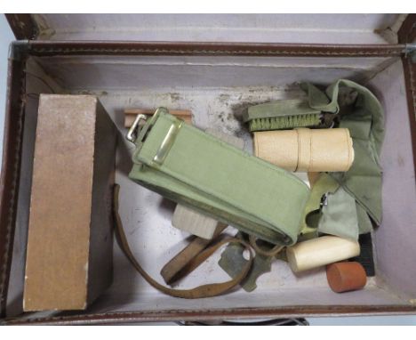 A small vintage case and contents to include military belts etc