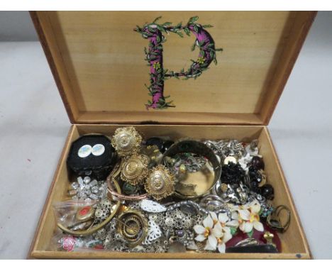 A treen box containing vintage costume jewellery