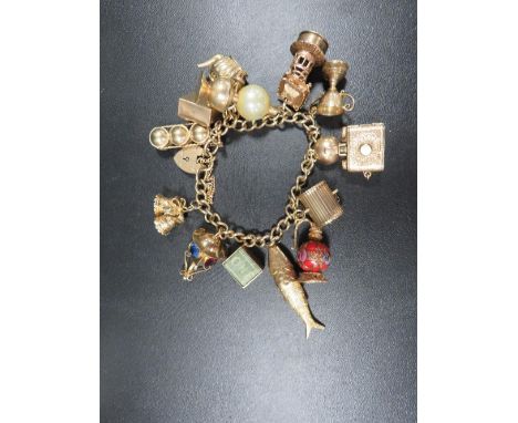 A vintage 9ct gold charm bracelet fitted with large 9ct gold charms, total weight approx. 75.2 g