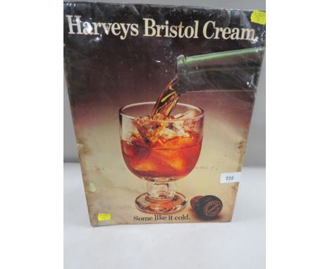 A vintage metal advertising sign laid on card for Harvey's Bristol Cream