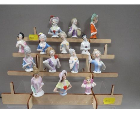 Fourteen vintage pin cushion dolls complete with display stand
