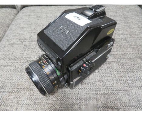 A vintage Mamiya 645 camera 1000s together with a Mamiya M645 prism finder