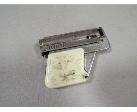 A vintage 'Imco, Gunlite' cigarette lighter, with white plastic grips