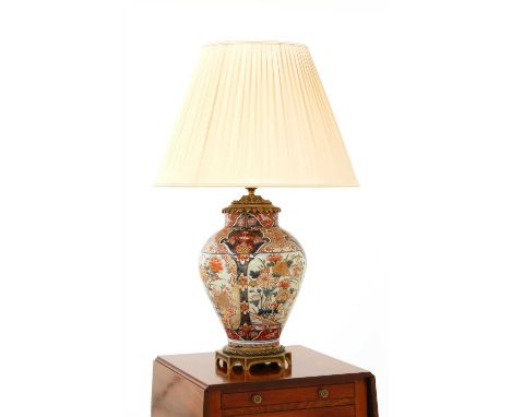 An Imari vase table lamp, with ornate gilt metal mounts and a silk shade, 95cm high overall