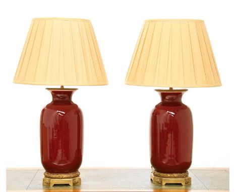 Two similar modern sang-de-boeuf vase table lamps, by Besselink &amp; Jones, London, with gilt bronze mounts and silk shades,