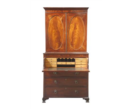 A George III strung mahogany secretaire bookcase, the associated top section with oval panelled doors enclosing adjustable sh