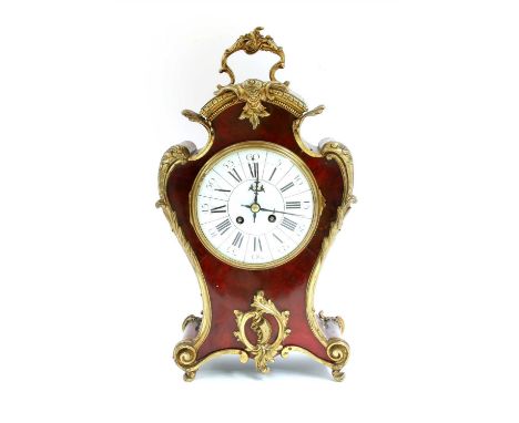 A French tortoiseshell and gilt bronze mantel clock, early 20th century, with an enamel dial, striking the hours and half hou