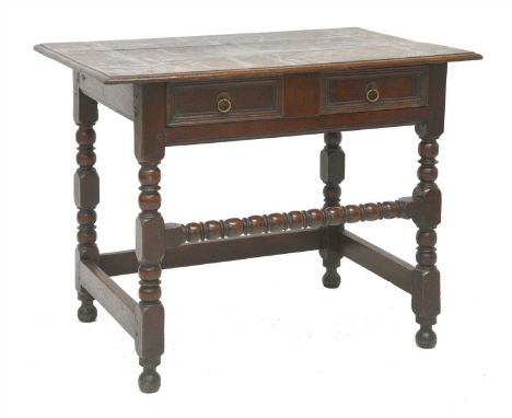 An oak side table, 17th century, with a single panelled drawer on ring and bobbin turned supports and front stretcher, 92cm w