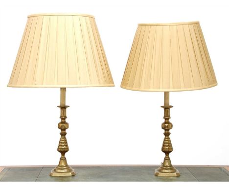 A pair of brass candlestick table lamps, 19th century, with knopped stems and stamped registration numbers, with silk shades,