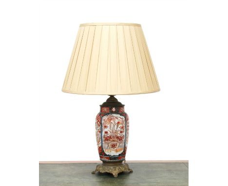 An Imari vase table lamp, the ribbed body within gilt metal mounts and a silk shade, 70cm high overall