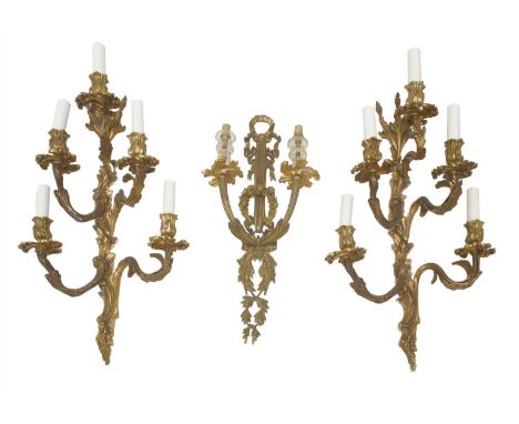 A pair of bronze five-branch wall lights, complete with shades, 59cm high, and a neoclassical-style twin-branch wall light, 5