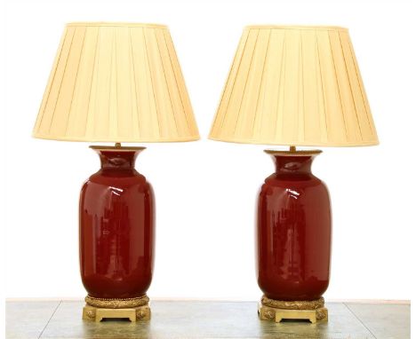 A pair of modern sang-de-boeuf vase table lamps, by Besselink &amp; Jones, London, with cast bronze mounts and silk shades, l