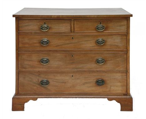 A strung mahogany chest of drawers, 19th century, having two short and three long drawers on bracket feet, bears label 'Towns