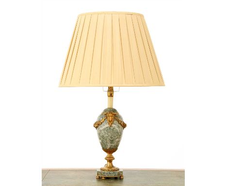 A French green-veined marble table lamp, of urn form with applied gilt metal mounts and a silk shade, 78cm high overall