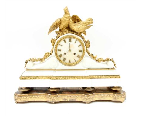 A French alabaster and ormolu mantel clock, late 19th century, surmounted by a pair of lovebirds and trailing flowers, the ci