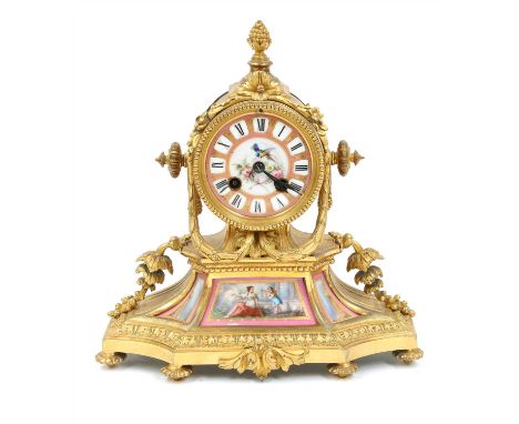 A French gilt bronze mantel clock, late 19th century, having a porcelain dial over three similar plaques, a striking drum mov