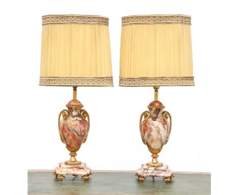 A pair of rouge veined marble table lamps, of ovoid shape, on serpentine stepped bases with gilt bronze mounts, with silk sha