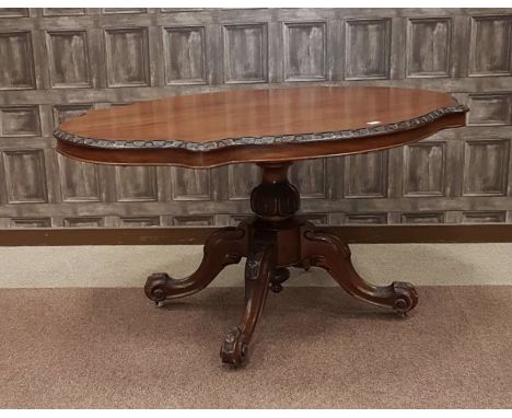 VICTORIAN WALNUT OVAL BREAKFAST TABLE, the restored top with arcaded border, on a carved baluster pillar, with quadruple scro