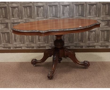 VICTORIAN WALNUT OVAL BREAKFAST TABLE, the restored top with arcaded border, on a carved baluster pillar, with quadruple scro