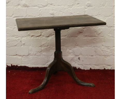 A Georgian square formed tripod table raised on a reeded centre pedestal.