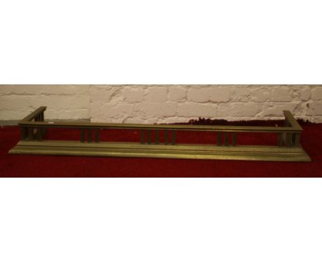 An Edwardian brass fire fender.