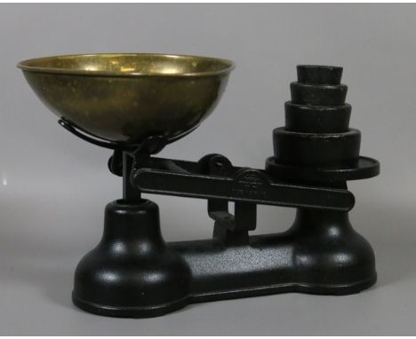 A pair of painted Salter scales with brass bowl and cast iron and brass weights.