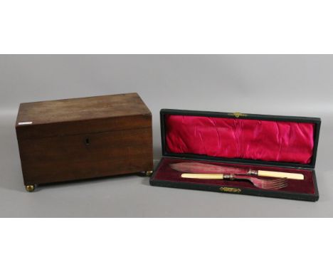 A Regency mahogany two section tea caddy raised on brass bun feet along with cased fish servers with silver ferrules and ivlr