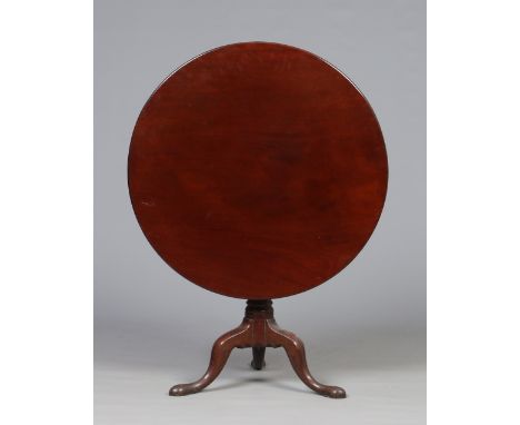 A Georgian mahogany centre pedestal snap top tea table with one piece top and raised on a plain turned centre column and rais