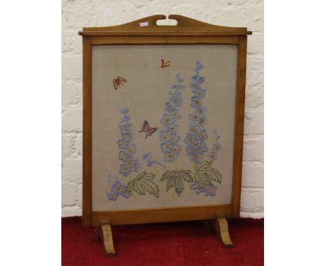 A light oak framed silk work fire screen with flowers and butterflies.
