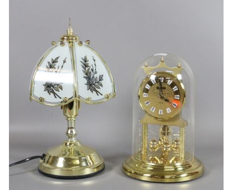 A brass based touch lamp and shade along with an anniversary clock.