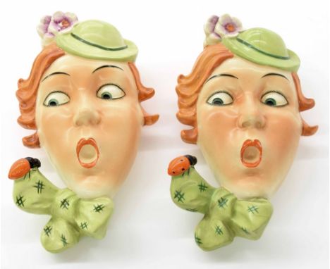 Pair of Czechoslovakian Art Deco wall masks/pockets, modelled as ladies startled by  bees on their bows, 9.5" high (one at fa