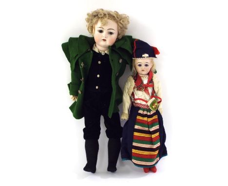 Two Continental bisque-headed dolls, the taller dressed in a green felt coat, suede waistcoat and breeches, 16" high and the 