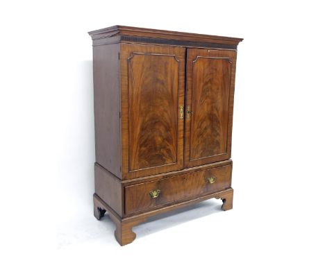 Georgian flame mahogany dwarf linen press, the moulded cornice over two panelled cupboard doors enclosing an interior of four