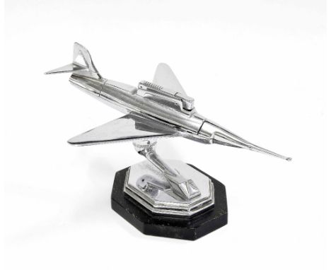 Chrome table lighter in the Dunhill style, modelled as a fighter jet on stand, upon an ebonised plinth, 5" high