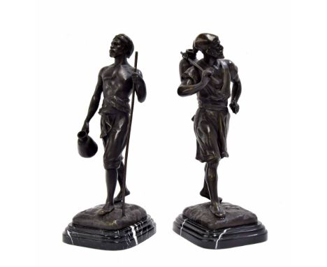 After Marel Debut - pair of bronze figures of Arab workers, carrying tools upon naturalistic bases mounted upon veined marble