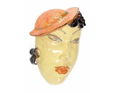 Art Deco terracotta wall mask in the style of Vally Wieselthier, modelled as a lady wearing an orange hat, 8" high