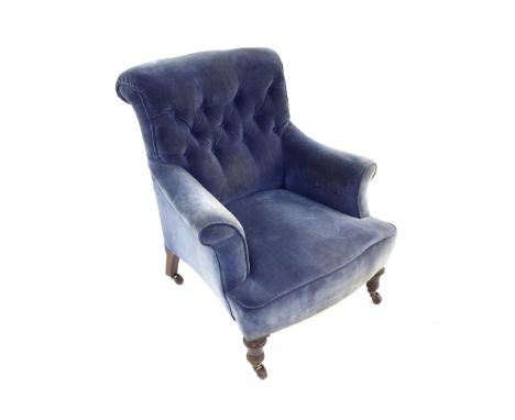 Victorian blue velvet button-back upholstered armchair with short turned front feet upon castors, 30" wide, 33" high, 28" dee