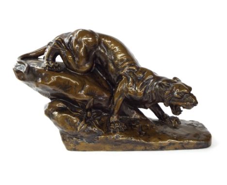 After Emile Rouff - painted bronze effect plaster figure of a prowling tiger modelled upon a naturalistic base, 13" high, 22"