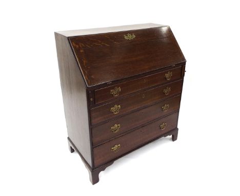Georgian style oak bureau, the fall-front enclosing a fitted interior over four graduated long drawers upon bracket feet, 36"