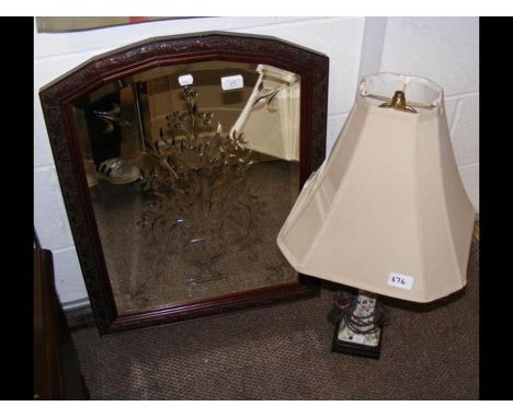 A bevelled wall mirror in mahogany surround, together with a floral table lamp 