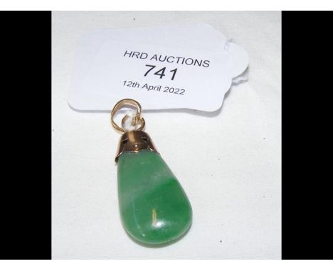 A jade pendant on yellow metal mount