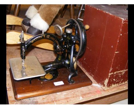 A vintage Willcox &amp; Gibbs Sewing Machine in case 