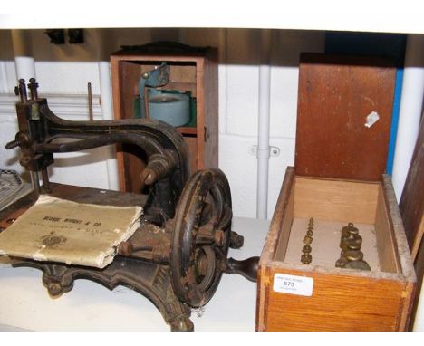 A George Whight &amp; Co. New 'Excelsior' Lock Stitch Sewing Machine, together with brass weights and a handheld military bub
