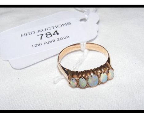 A five stone opal ring in yellow metal setting