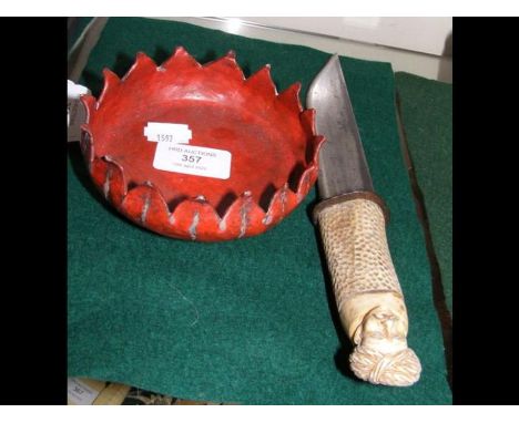 A 28cms Oriental dagger with carved handle together with a red painted Chinese metal bowl