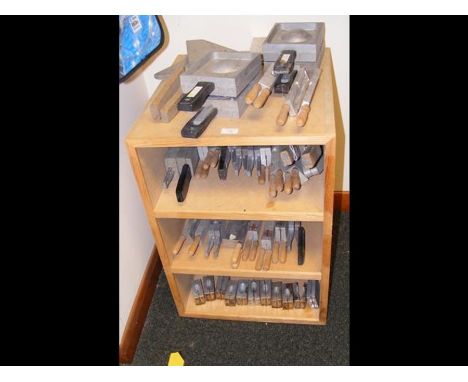 A wooden shelf unit containing large quantity of assorted down rigger and sinker molds etc. (cabinet included)